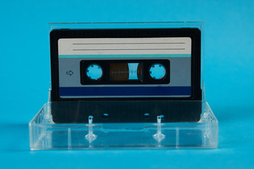 Blank cassette tape box on blue background. Vintage cassette tape case with retro cassette mockup. Plastic analog magnetic clear packaging template. Mixtape box open 