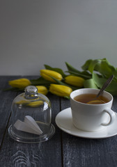 background with cap of tea, , tulips, paper`s airplane under glass (vertically)