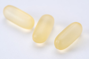 yellow white pills capsule isolated on white background