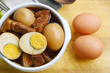 Eggs Stewed or Thai name is khai phalo muu saam chan on wooden background