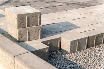 New pavement. Installing of concrete brick pavement to gravel foundation.