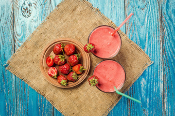 healthy strawberry yogurt with fresh berries on old wooden background
