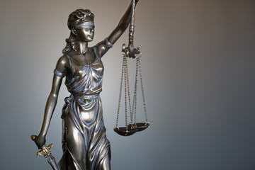 Statue of Justice with scales in lawyer office. Legal law, advice and justice concept