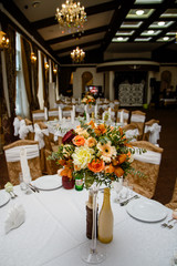 wedding decor on tables  in restaraunt, a bouquet of flowers with a glass vase