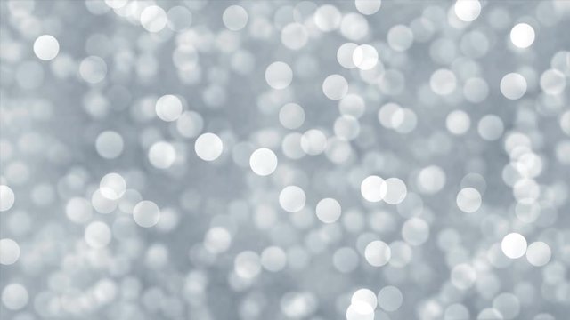 Abstract silver lights bokeh background. Blurred defocused glitter particles. Seamless loop.