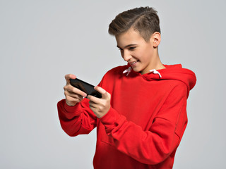 teenager playing games on smartphone