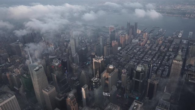 New York City daytime aerial view of Midtown Manhattan and Times Square with low clouds.