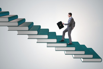 Businessman student climbing the ladder of education books