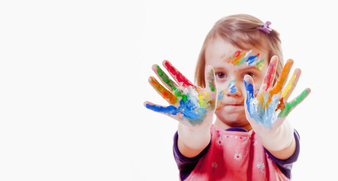 Colorful painted hands in a beautiful young girl (art, childhood, color)