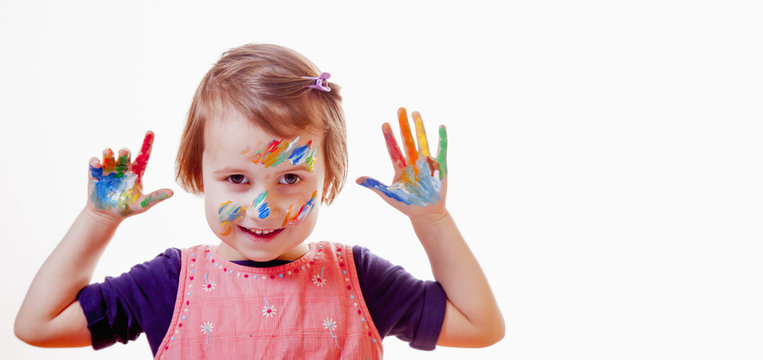 Beautiful little child girl with colorful painted hands. (art, childhood, color, creativity concept)