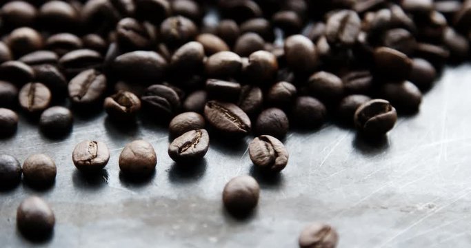 Closeup slow motion shot of roasted coffee beans