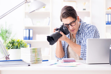 Young photographer working with his camera