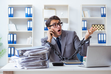 Busy employee chained to his office desk