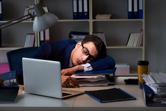 Businessman tired and sleeping in the office after overtime hour