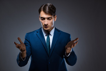 Businessman pressing virtual buttons on gray background
