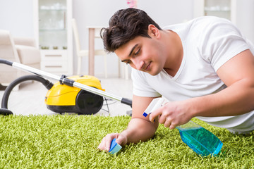 Young husband man cleaning floor at home