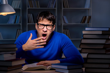 Student preparing for exams late at night in library