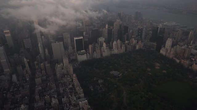 New York City aerial view of Midtown Manhattan from Central Park with fog and low level clouds at sunrise.