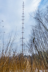 Radio tower in the winter forest. Russia
