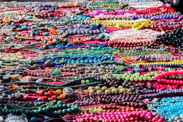 Colorful necklaces for sale at the flea market, consumption background, selected focus, narrow depth of field