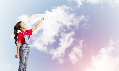 Concept of careless happy childhood with girl dreaming to become pilot