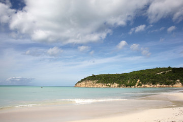 Beautiful landscape of Runaway Beach in Antigua, with golden sand, turquiose sea & blue sky, Caribbean.