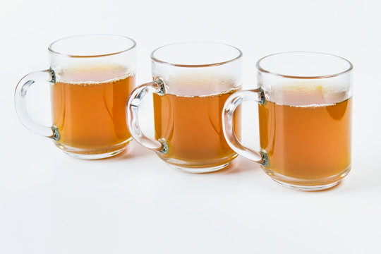 Three glass cups full of hot green tea drink on white background.