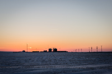 sihouette of oil refinery at sunset.