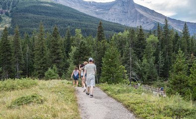 group of men and women hiking in the mountains