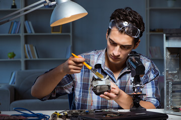 Computer repair man cleaning dust with brush 