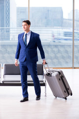 Businessman waiting at the airport for his plane in business cla