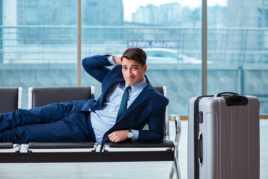 Businessman waiting at the airport for his plane in business cla