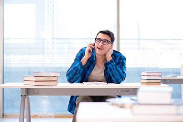 Student studying in the empty library with book preparing for ex