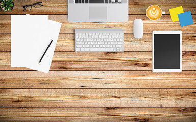 Modern workspace with coffee cup, paper, notebook, tablet or smartphone and laptop copy space on wood background. Top view. Flat lay style.