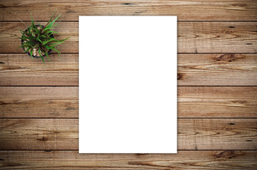 Top view of blank paper page on wood background office desk and different objects. Minimal flat lay style