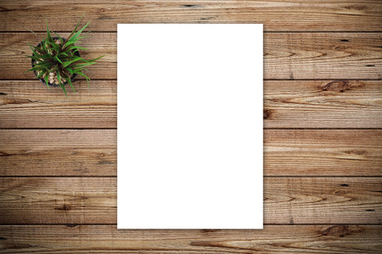 Top view of blank paper page on wood background office desk and different objects. Minimal flat lay style