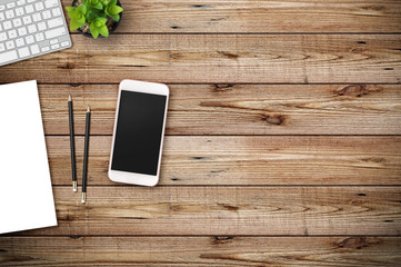 Modern workspace with coffee cup, paper, notebook, tablet or smartphone and laptop copy space on wood background. Top view. Flat lay style.