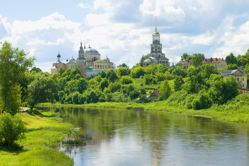 Naklejka premium Tvertsa river and Borisoglebsky monastery on a sunny July day. Torzhok, Russia