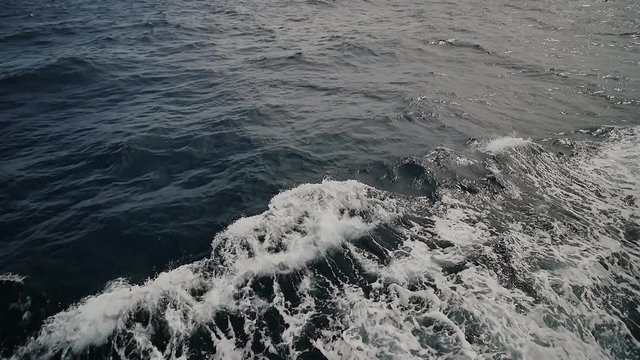 Foam wave of the sea surface from the movement of the ferry. A view of the spectacular sea of the islands of Palawan. Shooting in slow motion.