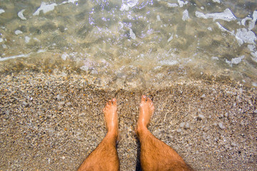 Selfie of man bare feet on sand beach and wave, summer concept