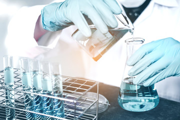 Scientist with equipment holding tools during scientific experiment science concept