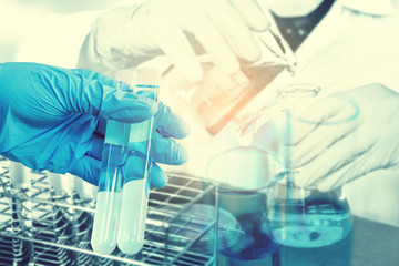 Scientist with equipment holding tools during scientific experiment science concept