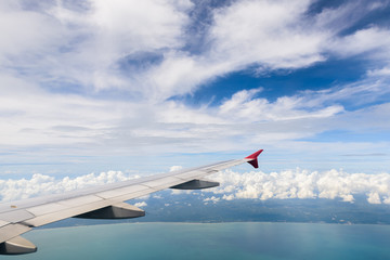 Wing of airplane with blue sky view.