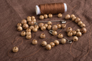 Pins, threads, and beads. On the fabric
