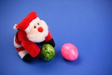 little santa claus with and pink easter egg