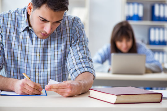 Students sitting and studying in classroom college