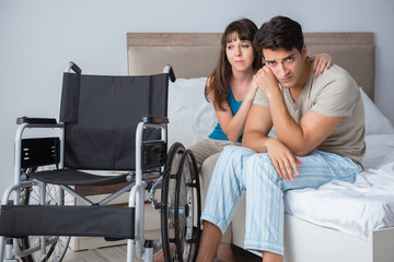 Fototapeta na wymiar Desperate man on wheelchair with his sad wife