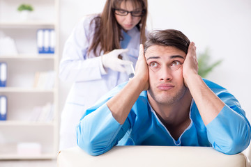 Funny man getting ready for buttocks syringe shot