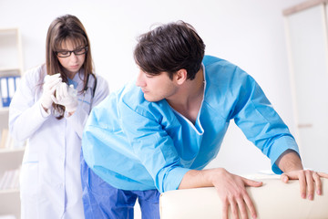 Funny man getting ready for buttocks syringe shot