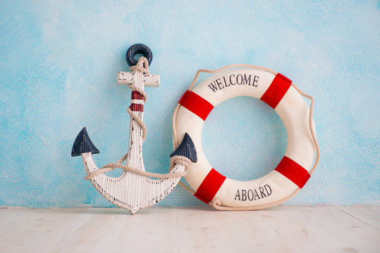 A composition on a sea theme with an anchor and lifebuoy on a blue wall